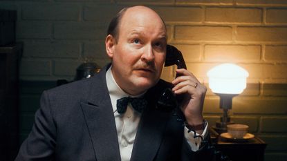 Henrik Dorsin as G&ouml;sta Engzell in The Swedish Connection, holding a telephone.