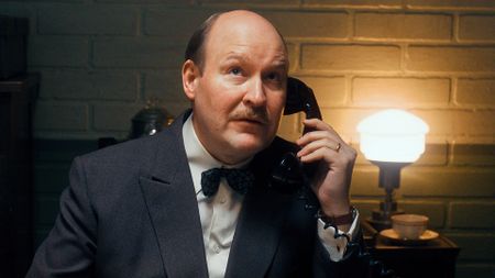 Henrik Dorsin as G&ouml;sta Engzell in The Swedish Connection, holding a telephone.