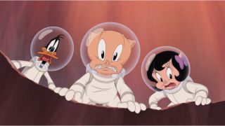 Daffy Duck, Porky Pig, and Petunia Pig look into a crater with concern, while dressed in spacesuits, in The Day The Earth Blew Up.