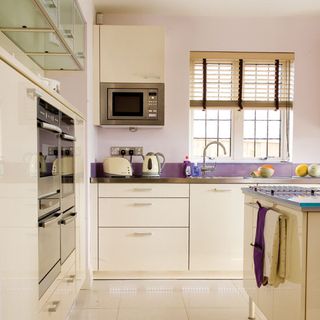 kitchen with white drawers and white flooring