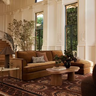 A living room with a brown wicker lamp on a side table from Lulu and Georgia