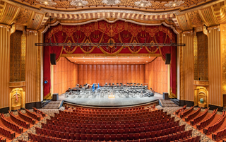 Warner Theatre, shown alit for an upcoming performance, modernized the sonic experience with JBL Professional speaker system.