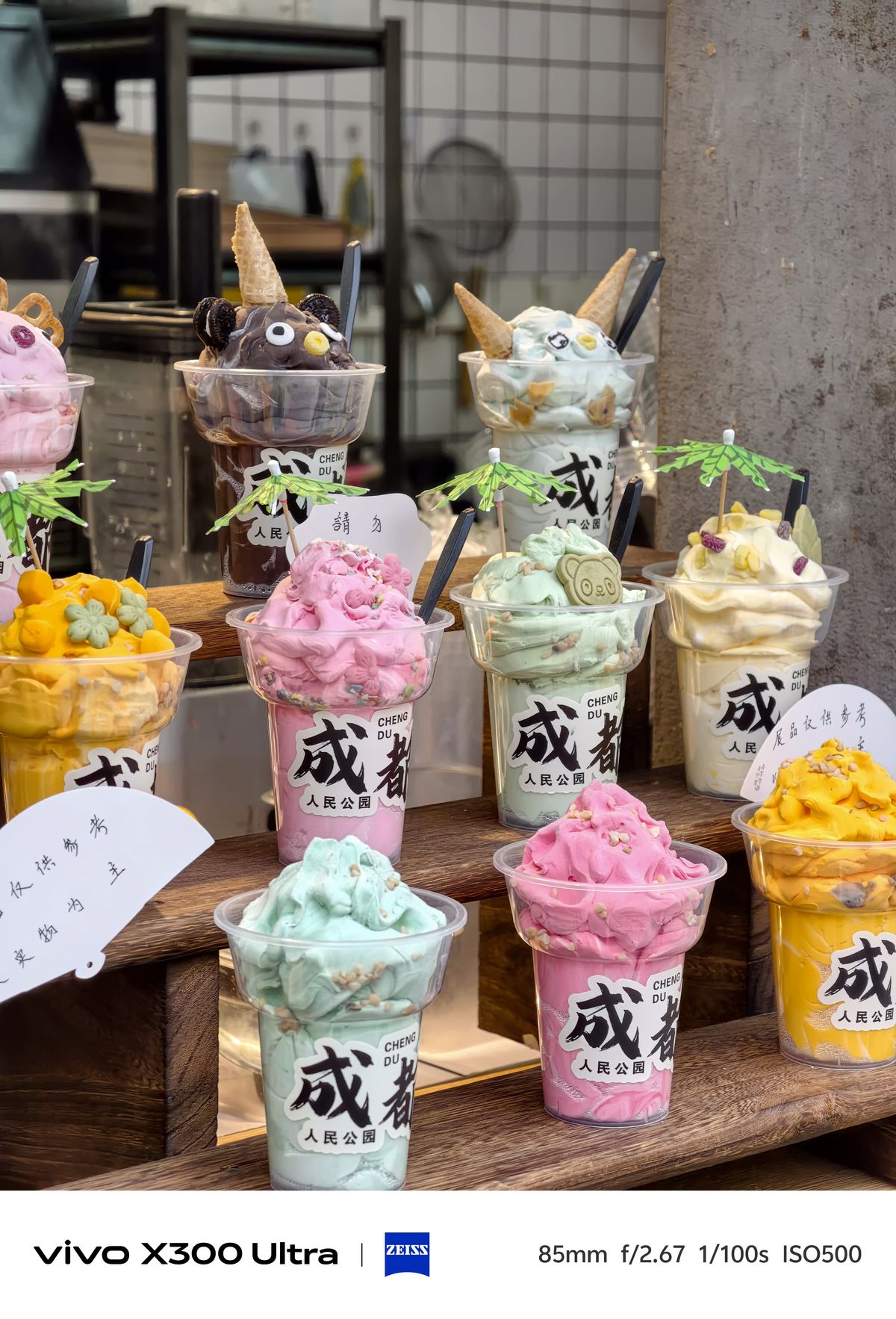 Colorful ice cream sundaes shaped like cartoon characters on a wooden shelf.