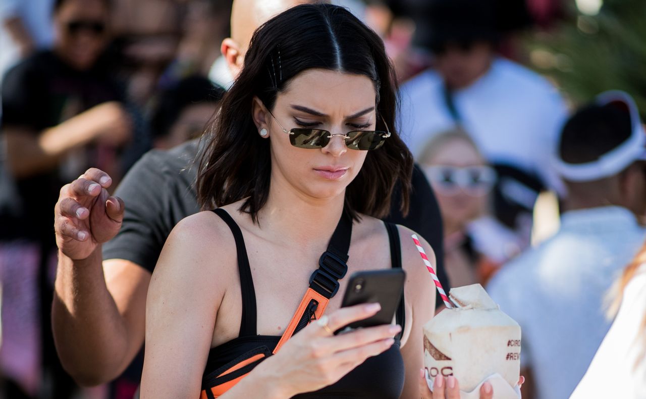 Kendall Jenner wearing cropped top, belt bag, military pants is seen at Revolve Festival on April 14, 2018 in Indio, California