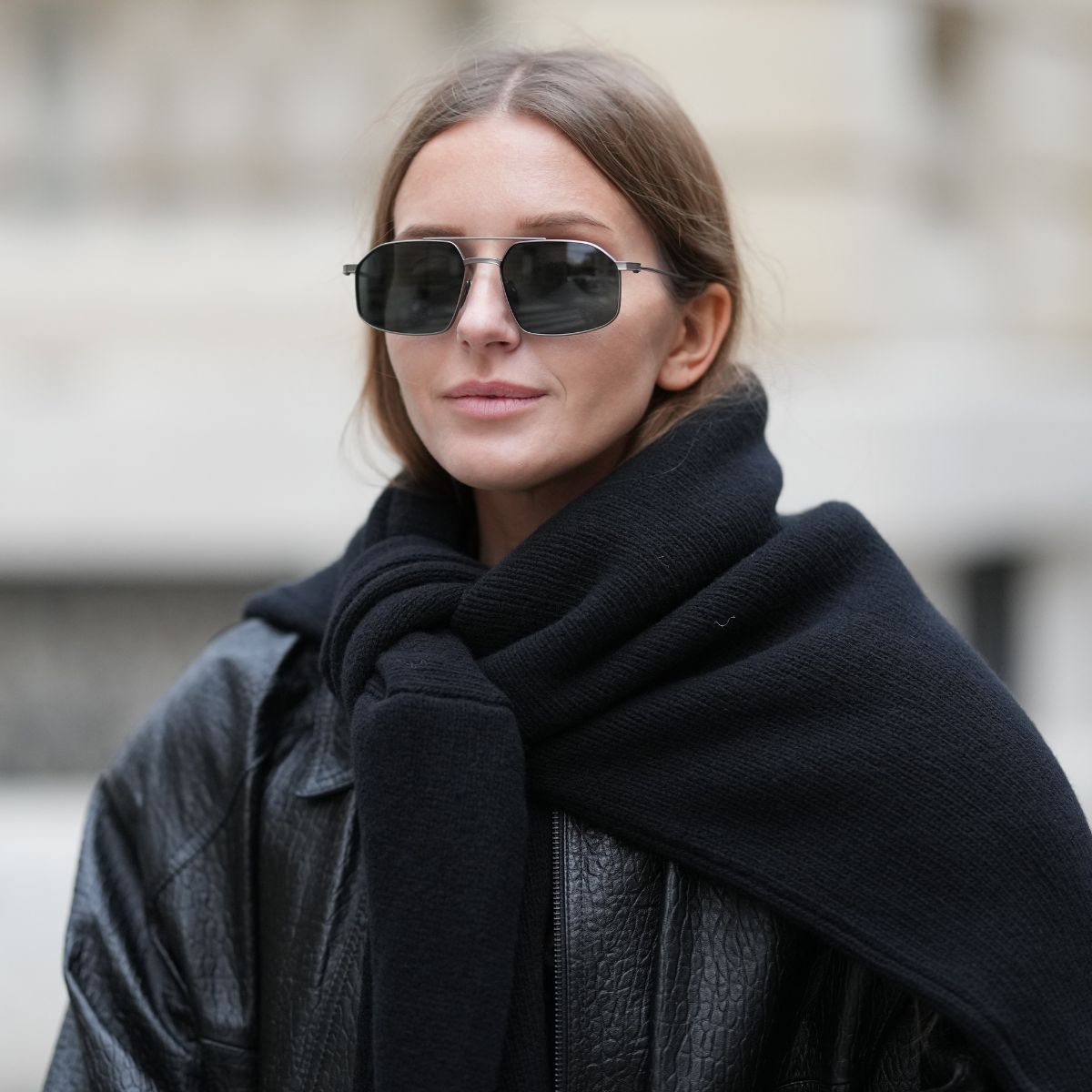 street style shot of woman wearing sunglasses and black jacket