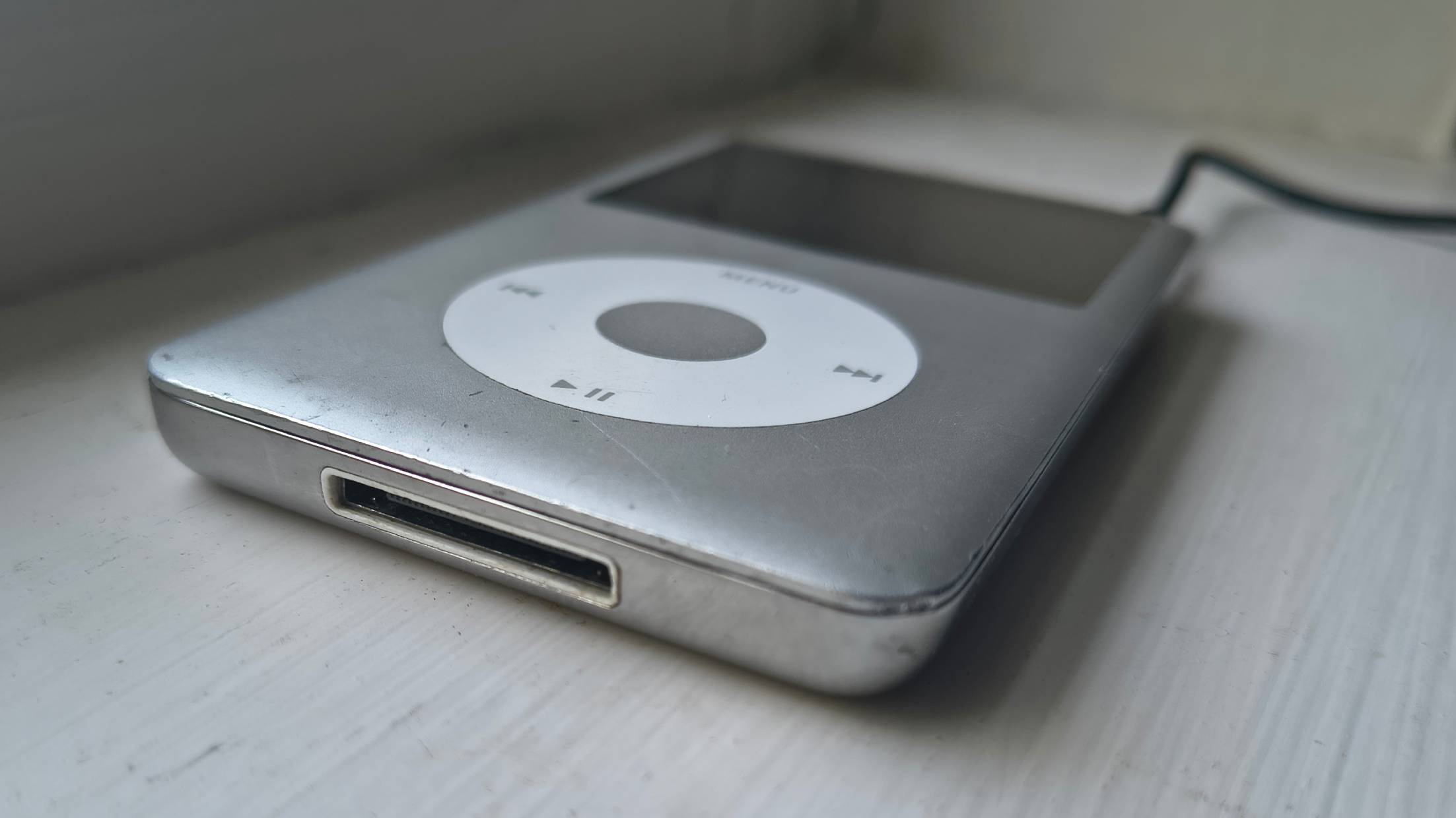 The iPod Classic on a window sill.