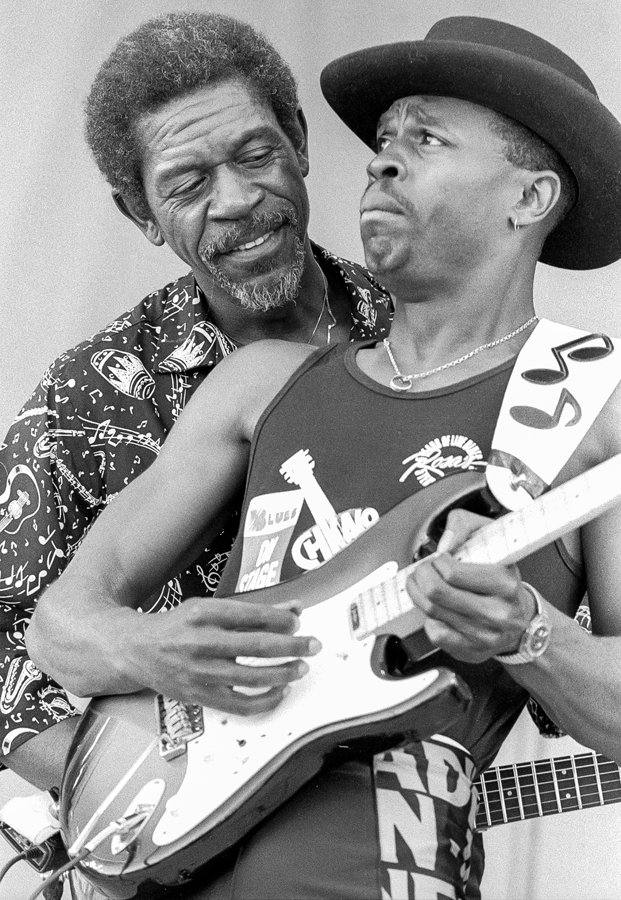 Blues musician Bernard Allison (fore) plays guitar with his father, fellow bluesman Luther Allison (1939 - 1997) at the 7th Annual Chicago Blues Festival, Petrillo Music Shell, Grant Park, Chicago, Illinois, June 8, 1990.