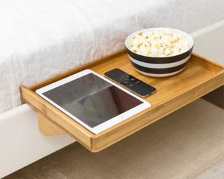 Smallish BedShelfie bedroom dorm shelf in natural bamboo with bowl of popcorn, white iPad and remote control