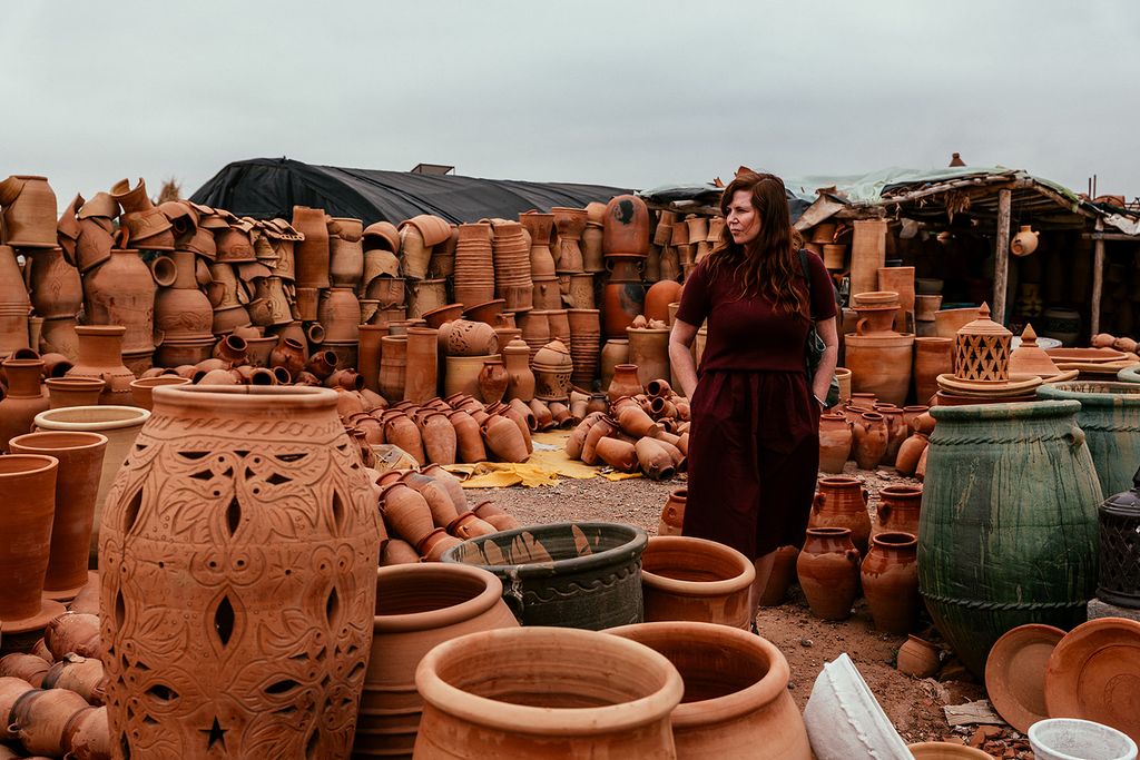 Woman standing around terracotta pots