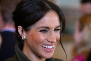 Britain's Meghan, Duchess of Sussex, smiles during a reception hosted by the Governor General at Admiralty House in Sydney on October 16, 2018