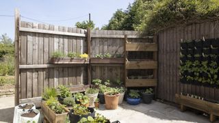 wooden garden fence around a container garden