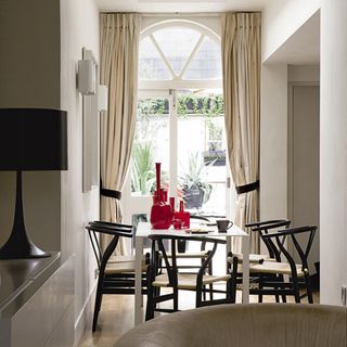 dinning room with table chairs and curtains on window