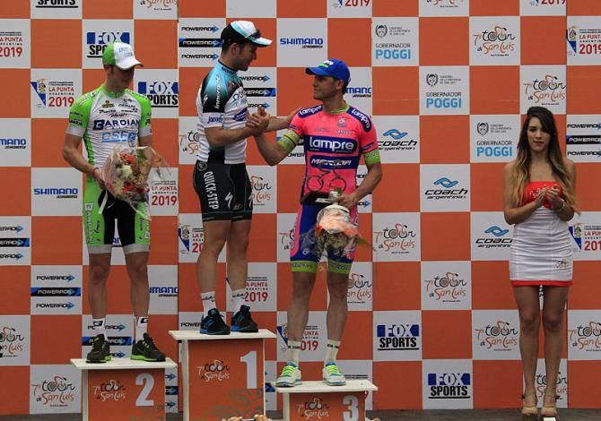 Stage 1 winner Mark Cavendish shakes hands with third place finisher Alessandro Petacchi on the podium in Villa Mercedes.