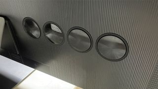 A shot of four circular speakers on the back of the Samsung QE65S95D QD-OLED TV.
