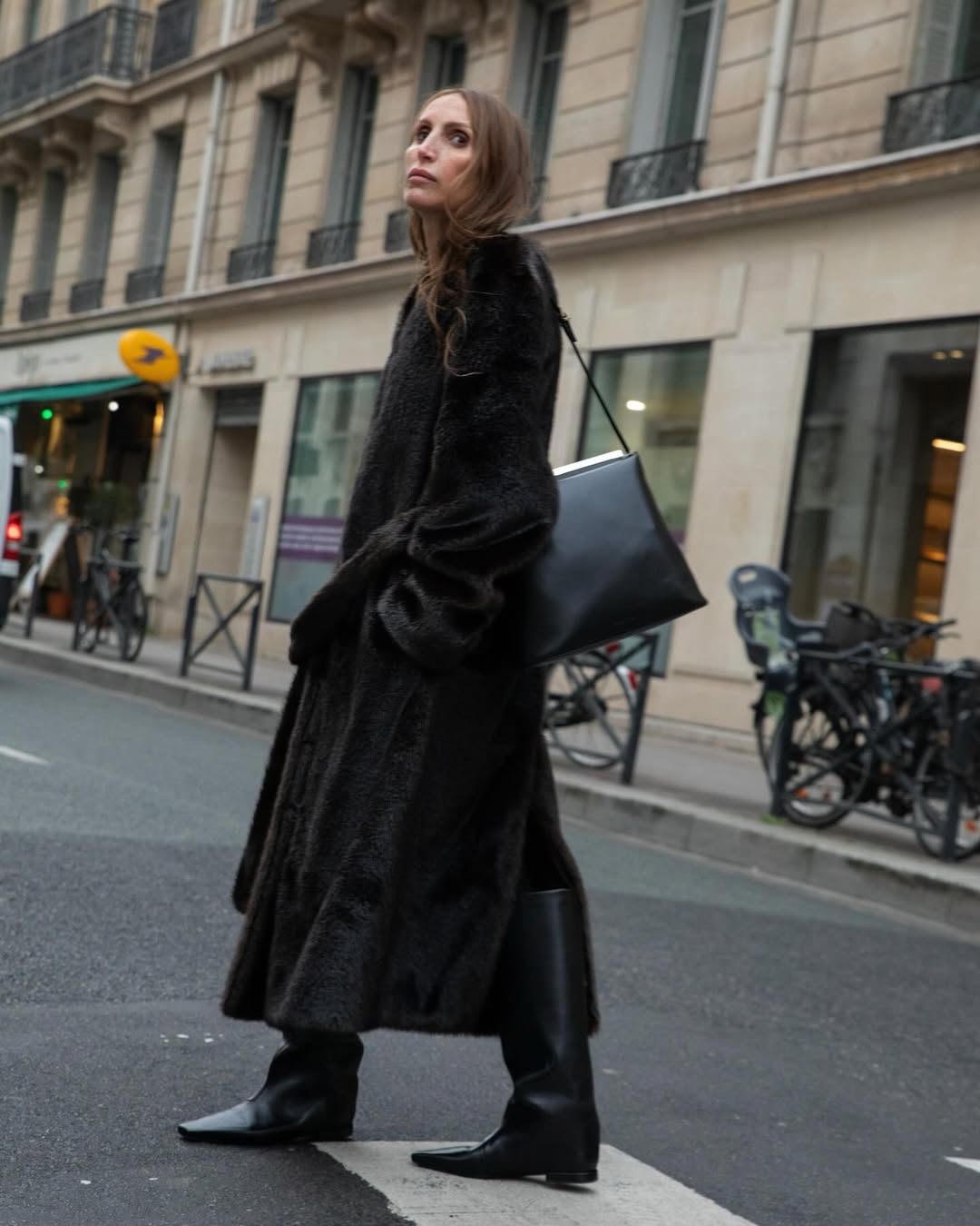 Woman in a long dark faux-fur coat