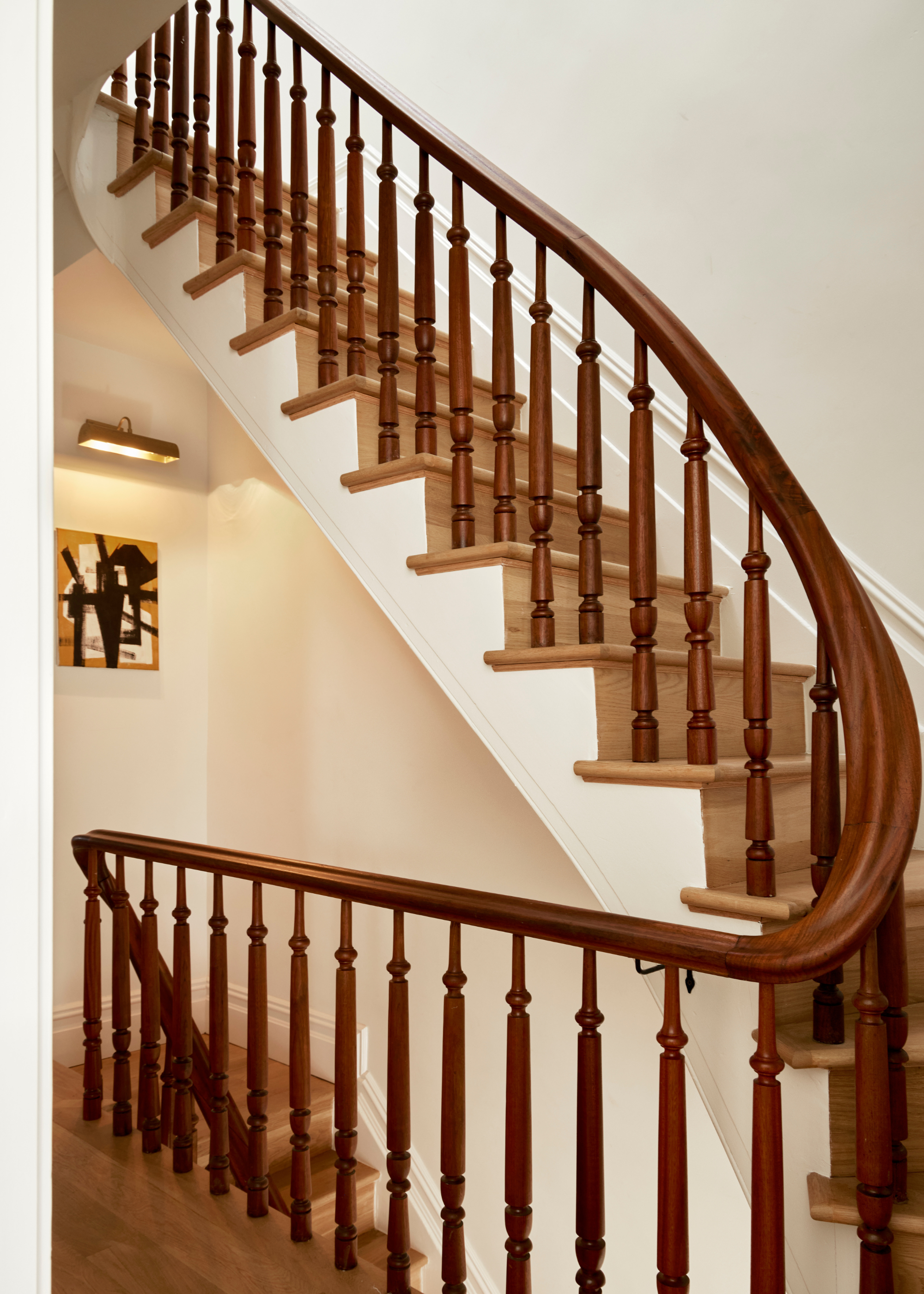 a wooden, traditional balustrade with a curving railing