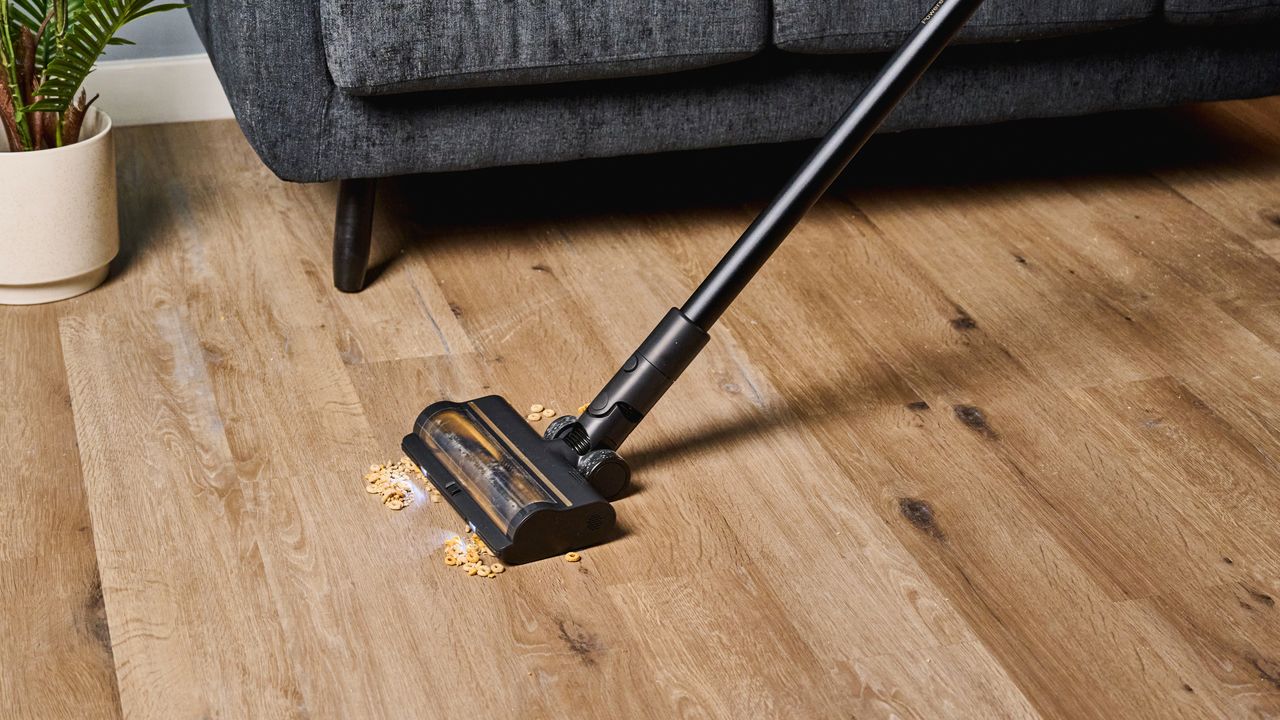 A black and gold Dreame R10 Pro cordless vacuum cleaner