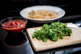 Watercress and tomatoes on a kitchen worktop