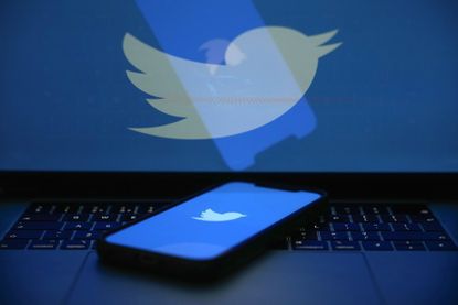 An image of the Twitter bird logo on a phone and a larger screen