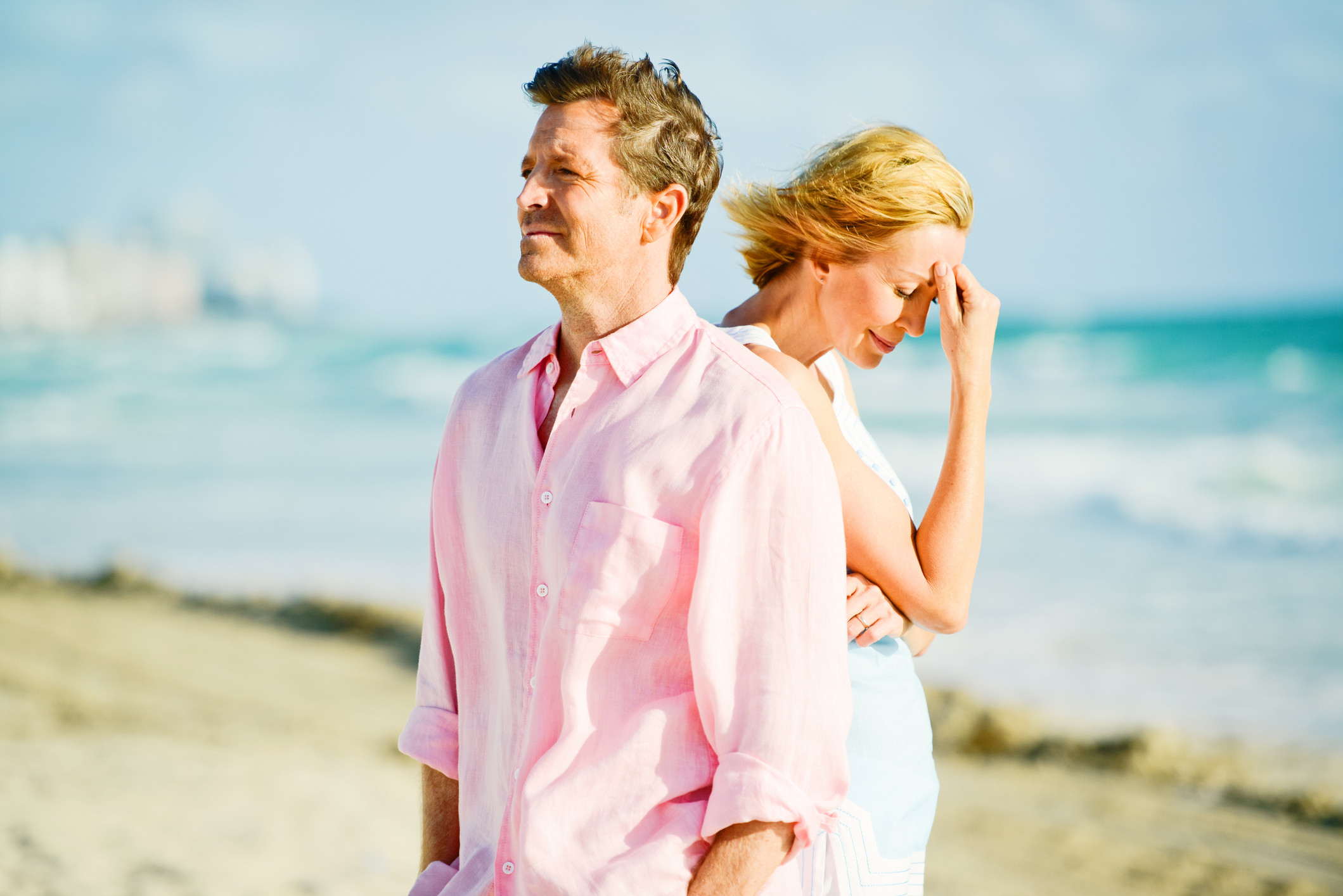 Unhappy Mature Couple Walking on the beach