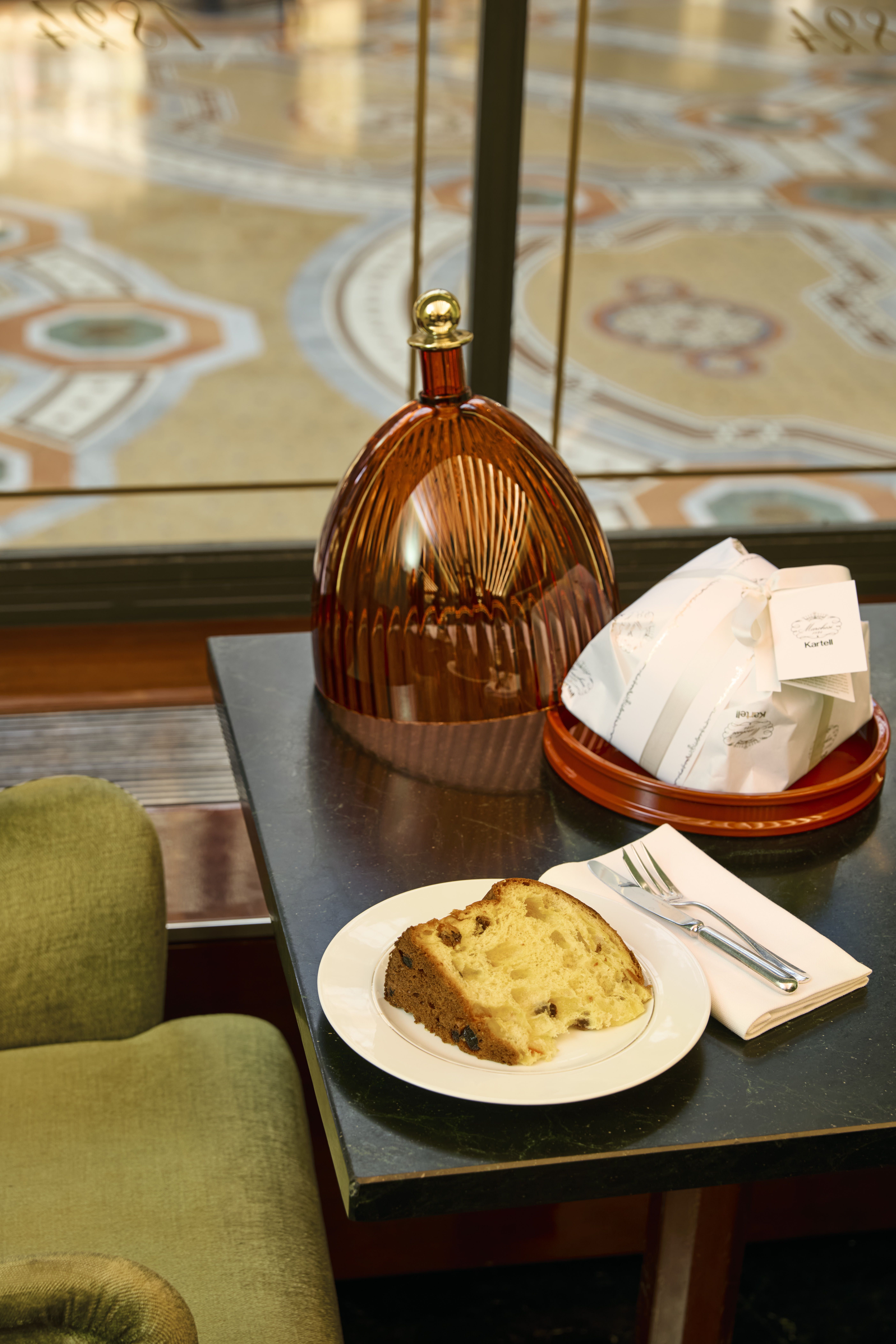 a slice of panettone and a cake dome