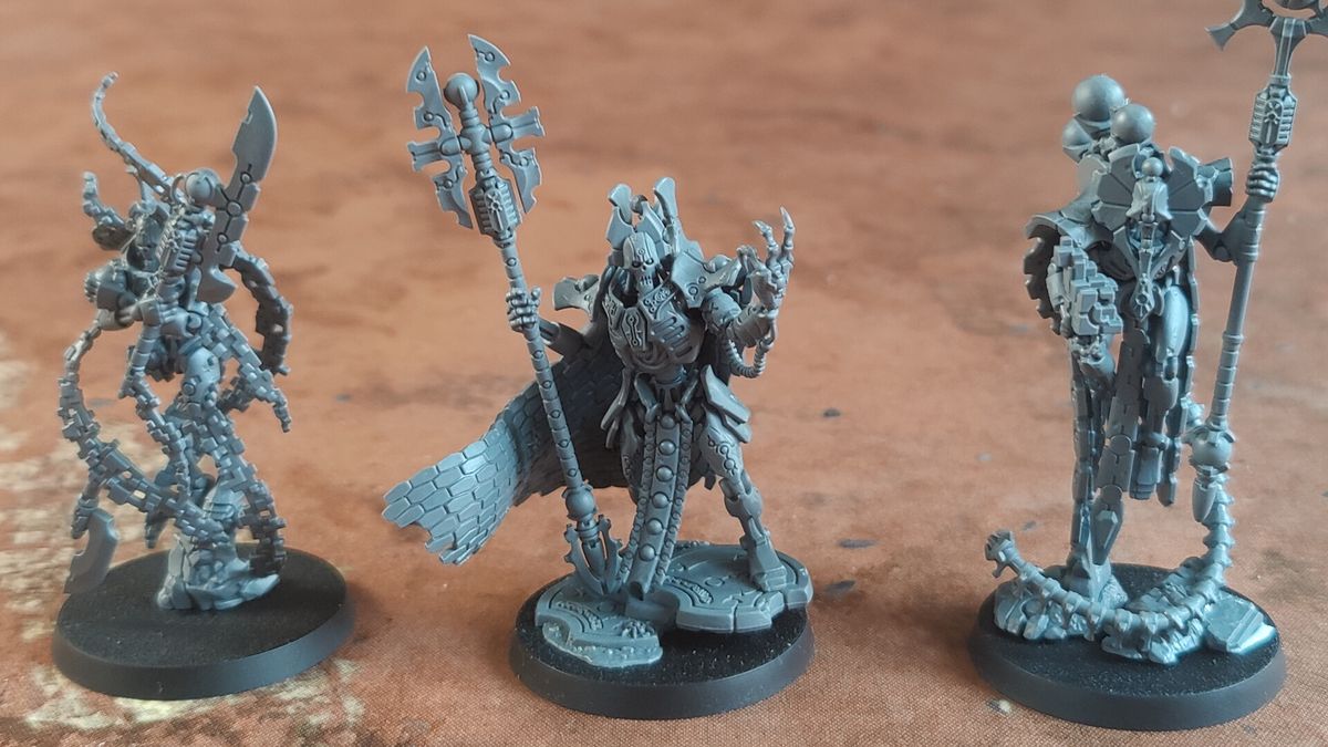 The trio of new Necron models for Warhammer 40K, arrayed on a battlemat