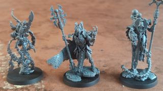 The trio of new Necron models for Warhammer 40K, arrayed on a battlemat