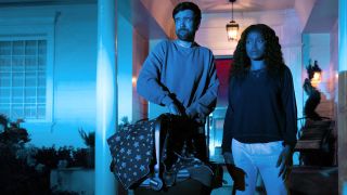 Samira and Rob standing in front of their house at night n The Burbs