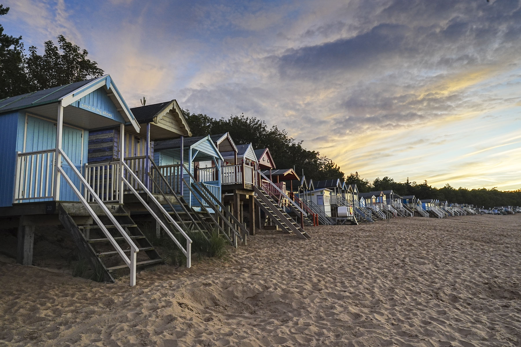 Sample image taken with the Sony FE 16-35mm F2.8 GM II of beach huts at golden hour