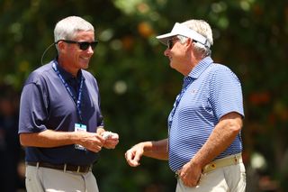 Jay Monahan and Jimmy Dunne chat during a golf event