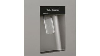 A closeup of the Hisense American Fridge Freezer's non-plumbed water dispenser.