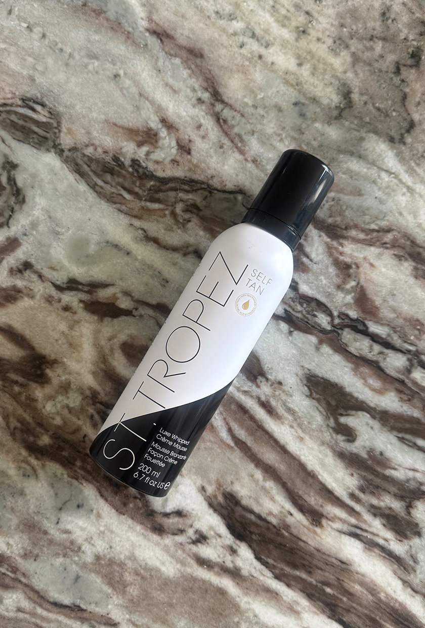 st tropez fake tan mousse bottle on table