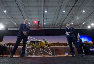 Col. Michael Hough, Commander 30th Space Wing, Vandenberg Air Force Base, left, and 1st Lieutenant Kristina Williams, weather officer, 30th Space Wing, Vandenberg Air Force Base, discuss NASA's InSight mission during a prelaunch media briefing, Thursday, May 3, 2018, at Vandenberg Air Force Base in California.
