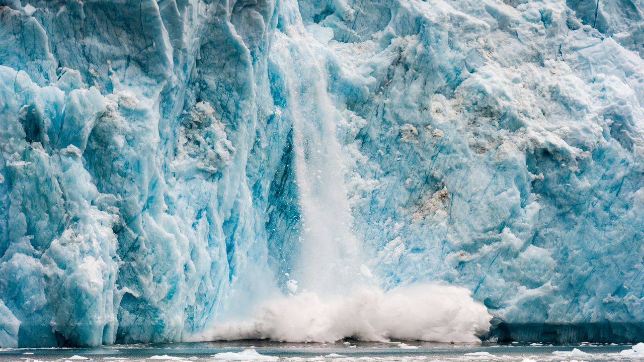 Fracturing glacier into water in Greenland.