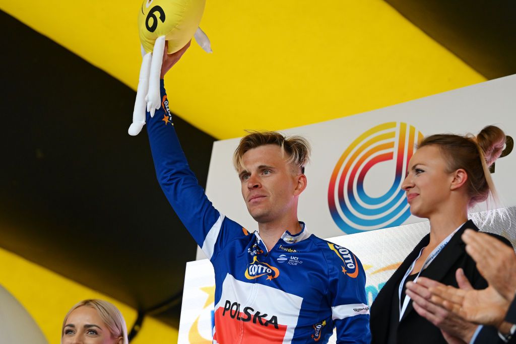 OPOLE POLAND AUGUST 01 Patryk Stosz of Poland and Team Poland celebrates at podium as Blue Active Rider Jersey winner during the 80th Tour de Pologne 2023 Stage 4 a 1991km stage from Strzelin to Opole UCIWT on August 01 2023 in Opole Poland Photo by Dario BelingheriGetty Images