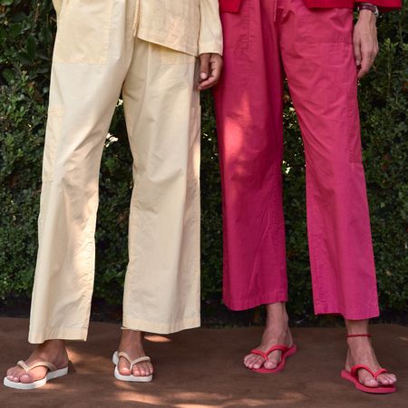 two models wearing Donni pants with coordinating flip flops