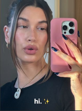 Hailey Bieber wearing a blackberry manicure