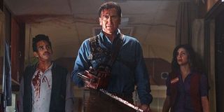 Ash vs Evil Dead Bruce Campbell proudly stands blood splattered between two companions
