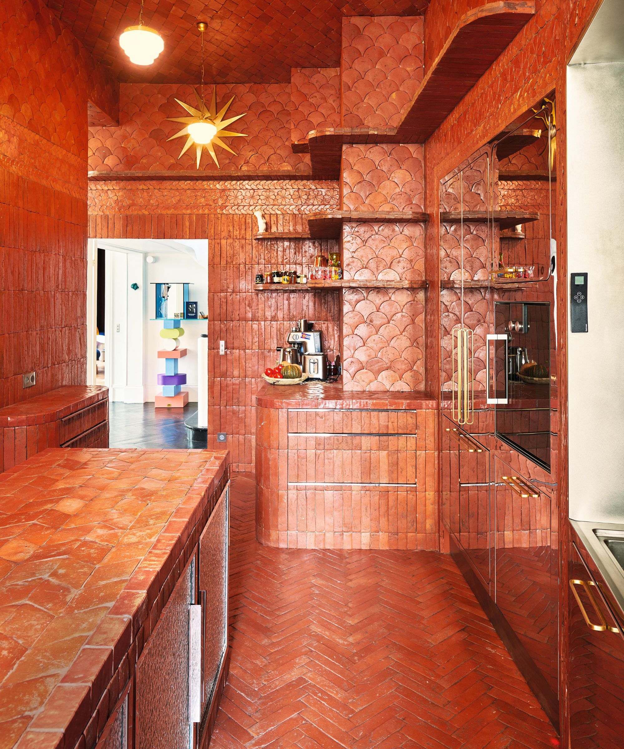 an orange floor to ceiling tiled kitchen in paris