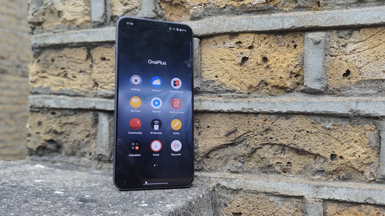 The OnePlus Nord 5 against a brick wall.