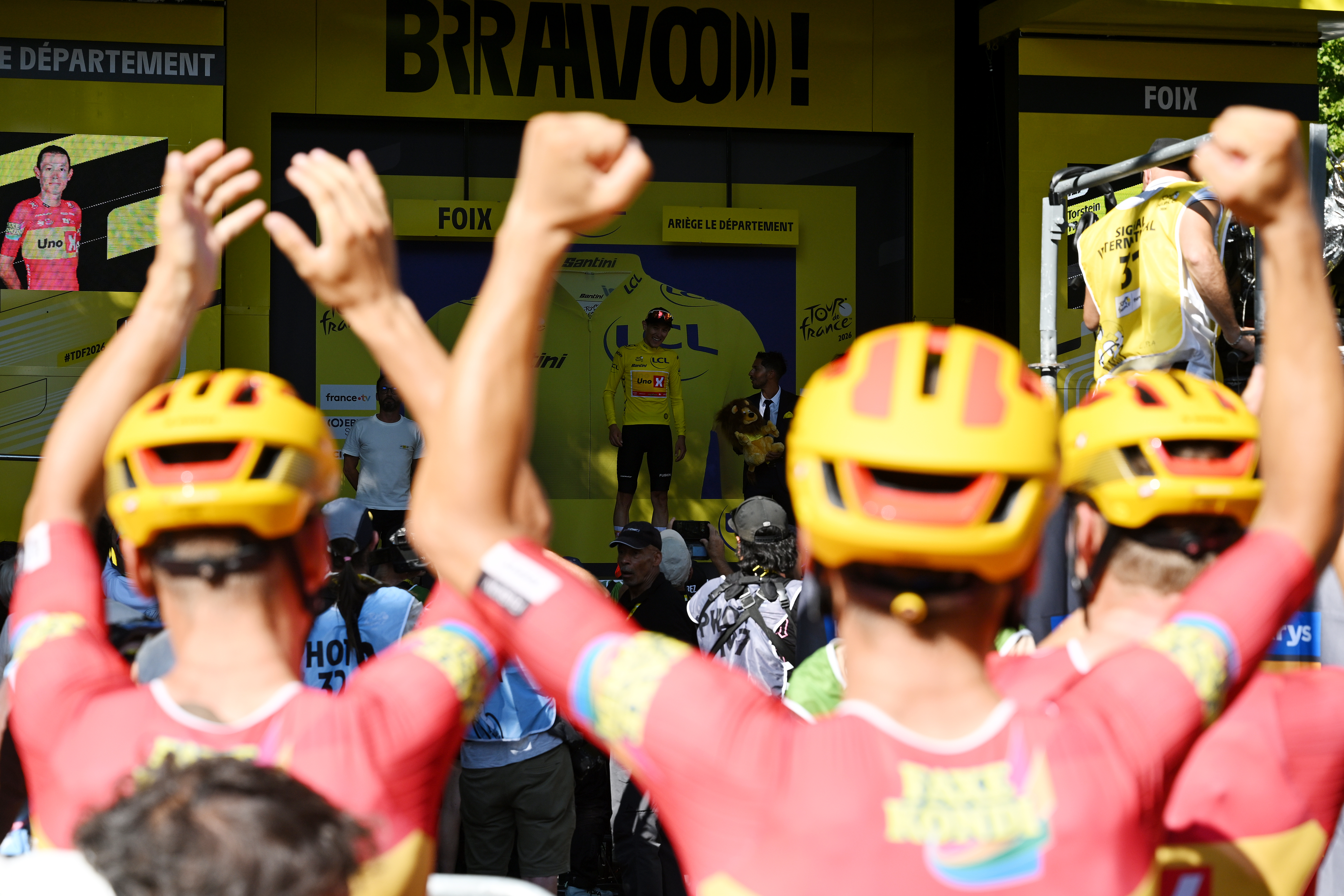 FOIX, FRANCE - JULY 07: Rider detail view of Team Uno-X Mobility celebrate at podium the victory of his teammate Torstein Traeen of Norway as Yellow Leader Jersey winner during the 113th Tour de France 2026, Stage 4 a 181.9km stage from Carcassonne to Foix / #UCIWT / on July 07, 2026 in Foix, France. (Photo by  Dario Belingheri/Getty Images)