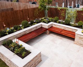 modern patio with stone garden wall and built in bench seating