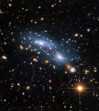 This image from the NASA/ESA Hubble Space Telescope shows the galaxy cluster MACS J0416. This is one of six galaxy clusters being studied by the Hubble Frontier Fields program, which together have produced the deepest images of gravitational lensing ever made. Scientists used intracluster light (visible in blue) to study the distribution of dark matter within the cluster.