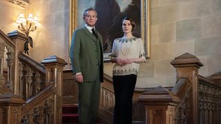 Hugh Bonneville and Michelle Dockery stand on the staircase in Downton Abbey: A New Era