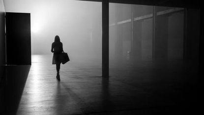 Woman walking alone in dark