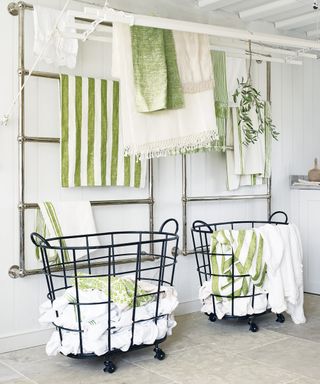 Laundry room with wheeled baskets and towel rails