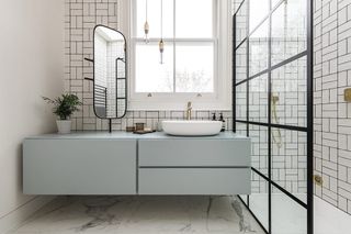 an ensuite bathroom with a vanity in front of a window