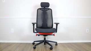 The Herman Miller Vantum in black and red up against a wall