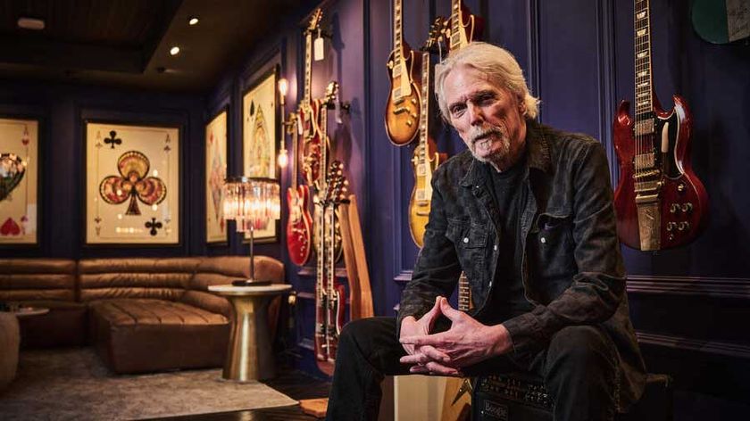 Scott Gorham in a room full of guitars