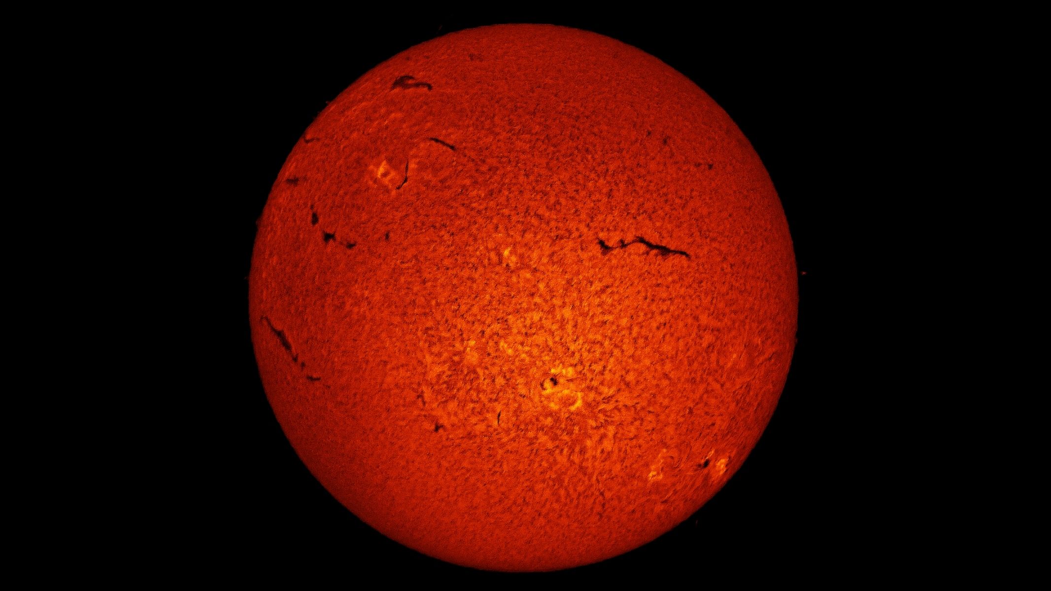 The solar disk in deep orange with wrinkles, surrounded by a black background, as imaged by the ZWO ASI174mm mono camera.